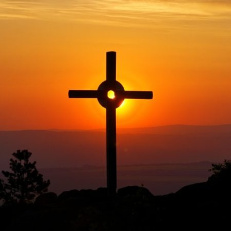 Cross on a hill at sunset